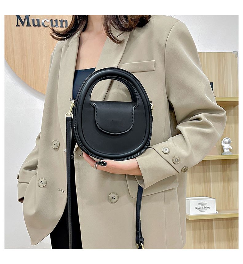 Round faux-leather crossbody bag