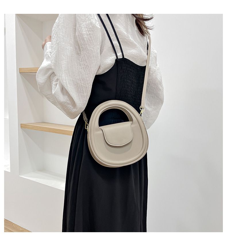 Round faux-leather crossbody bag