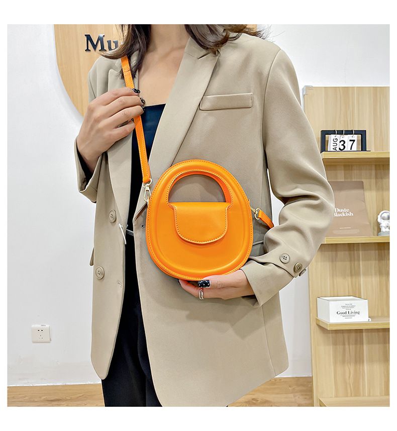 Round faux-leather crossbody bag